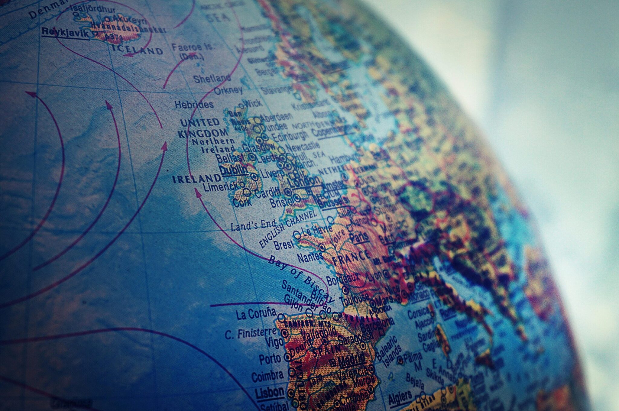 Detailed close-up of a globe showing parts of Europe and the Atlantic Ocean.