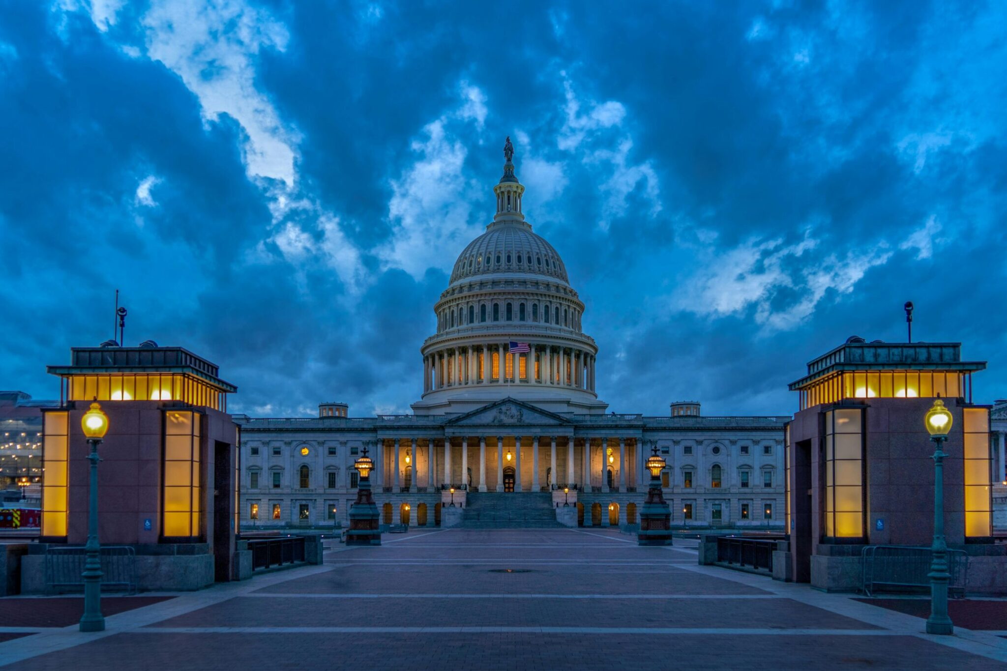 Dramatic twilight view of the United States Capitol in Washington, DC with moody evening skies.